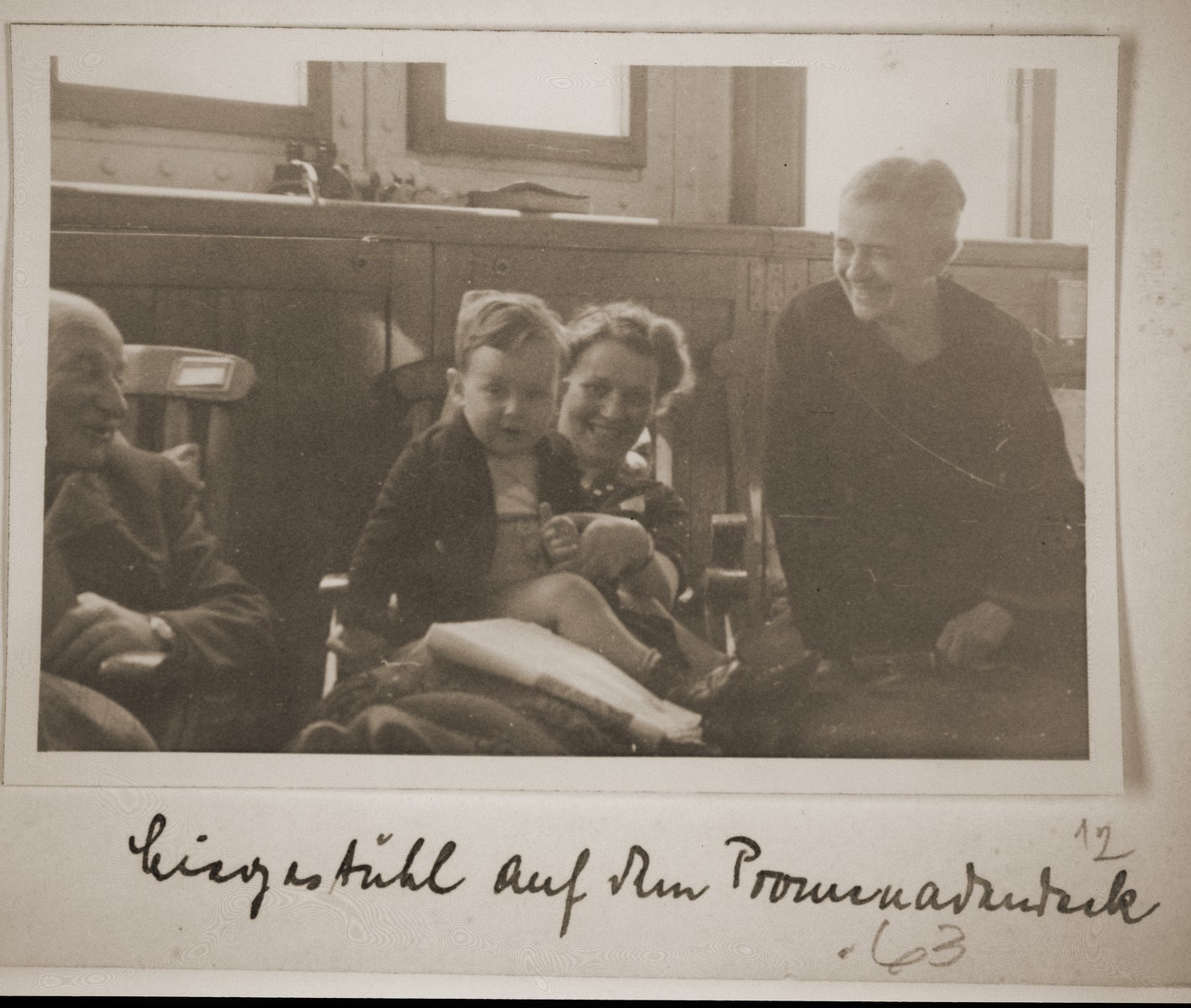 The Vendig family sits on the promenade deck of the St. Louis.