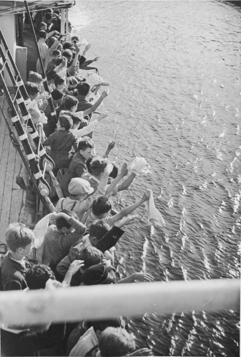 A group of Jewish children from Germany wave to their Danish hosts from the deck of the ship that is taking them home after their stay at a Kinderlager [children's recreational summer camp] in Horserod, Denmark. 
 
In 1935-36 Norbert Wollheim was involved in organizing groups of German Jewish youth to attend a summer camp in Denmark.
