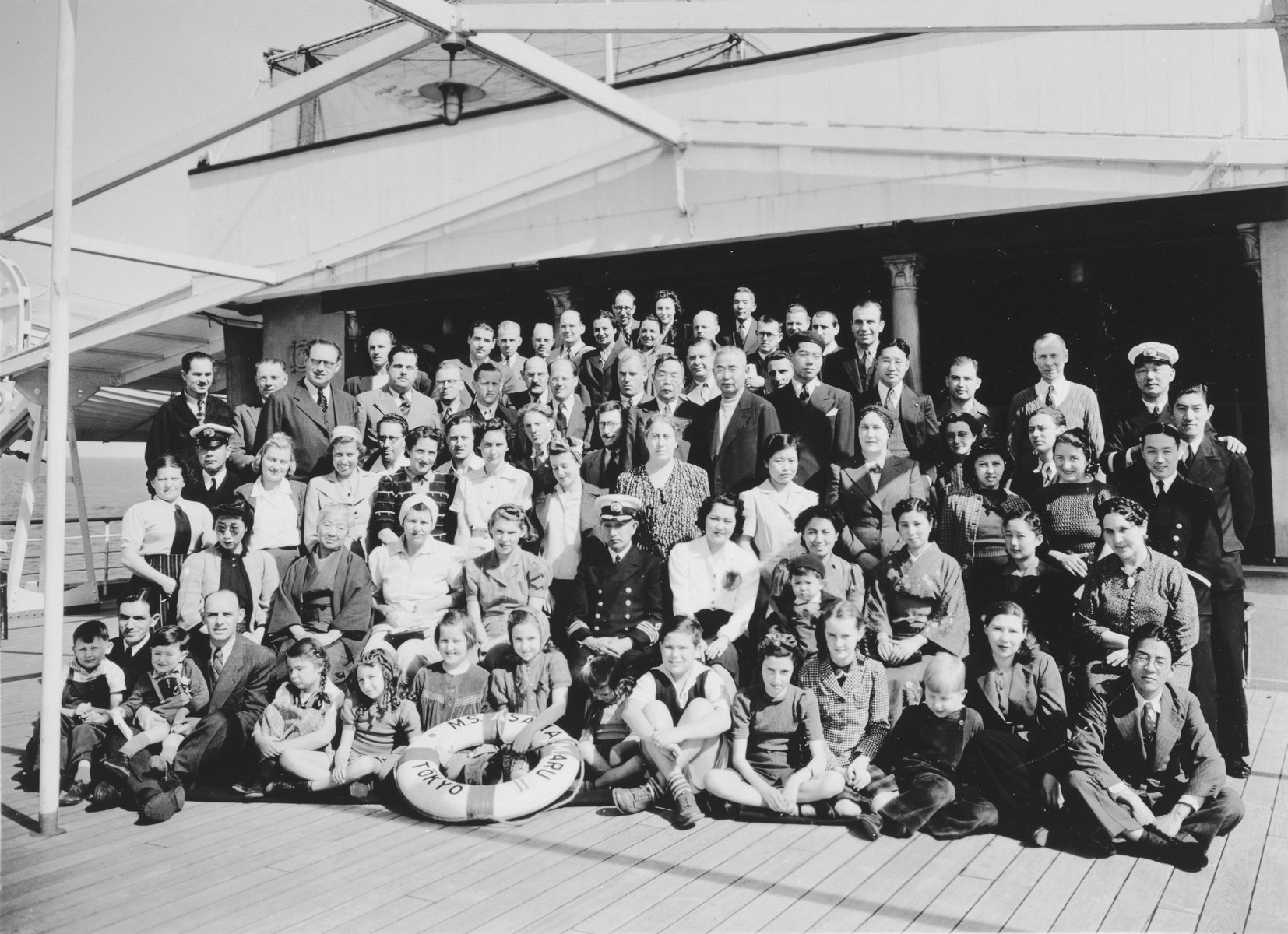 Group portrait of passengers on board the Asama Maru en route from Yokohama via Oahu to San Francisco.

Among those pictured are the ships' crew, Irena Malowist (sitting in the front row, fifth from the right); her mother Maria Malowist (standing in the third row, sixth from the left) and her father Szymon Malowist (standing at the back).