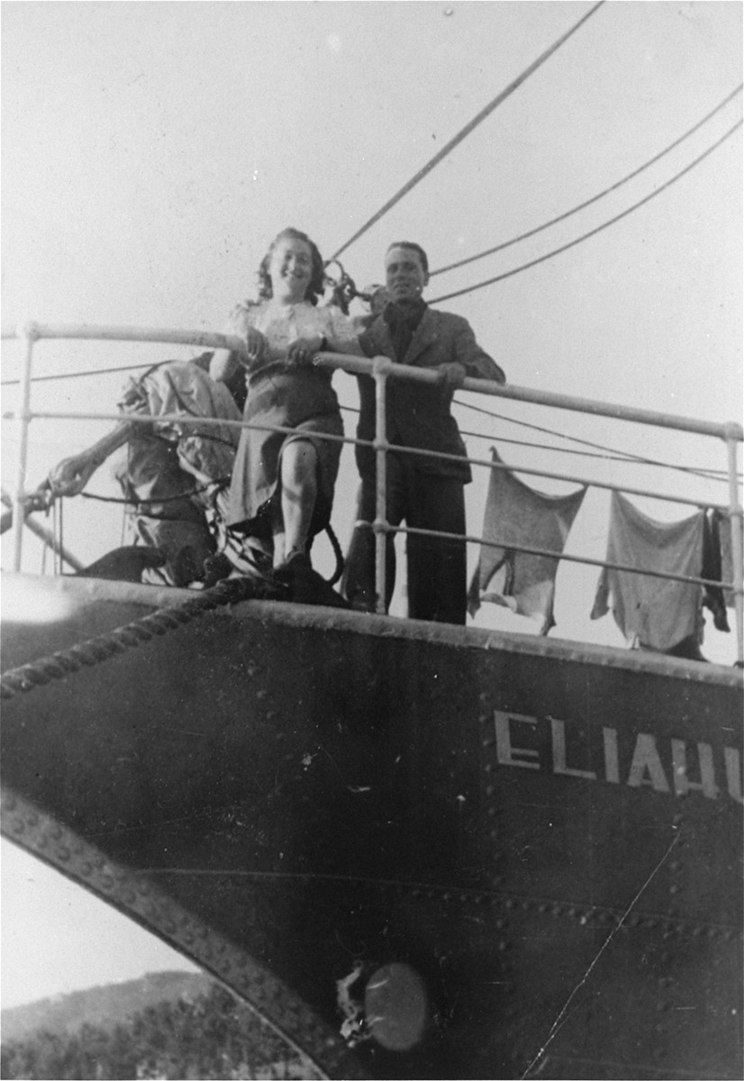 Hadasa Werdygier stands with an Italian Jew on the deck of the Dov Hos right before it set sail for Palestine.