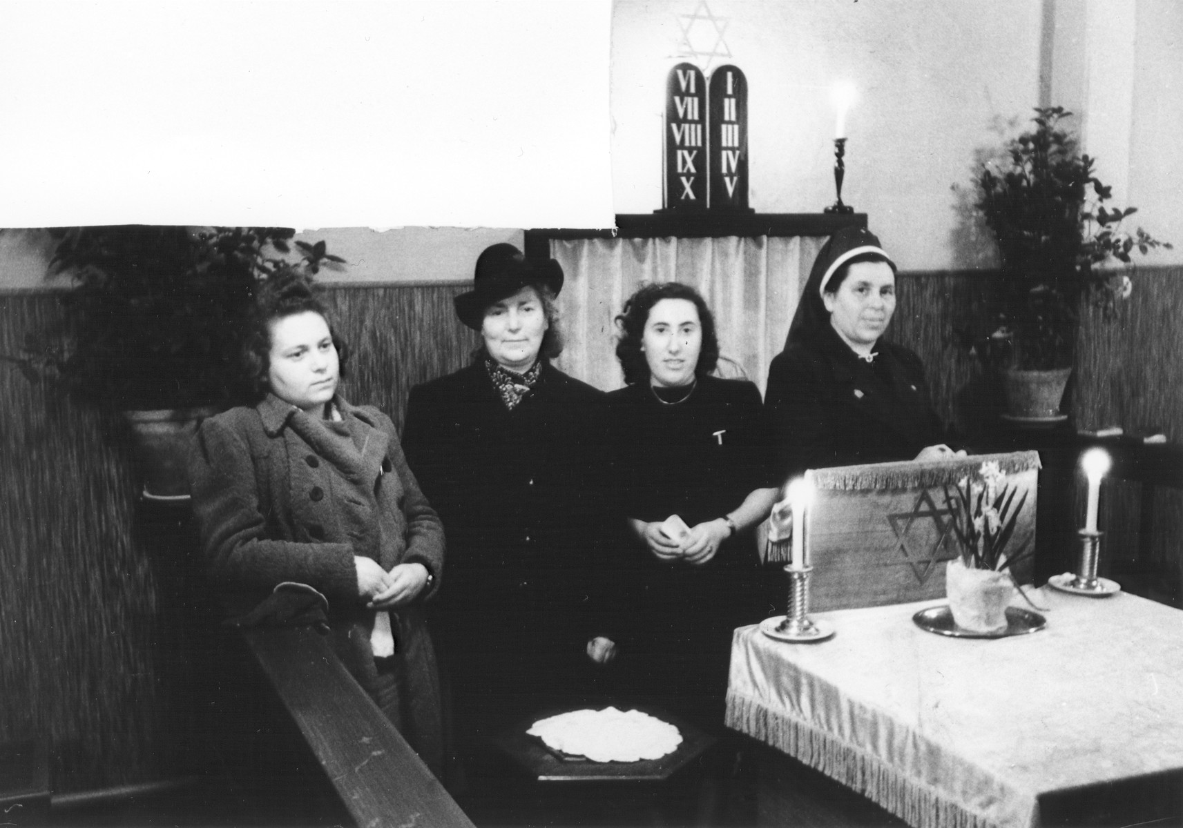Four women sit in the chapel at U.S. Army 3rd Division headquarters in Bad Wildungen.

Pictured (left to right) are Erika Mannheimer, her mother Lina Mannheimer, Selma Hammerschlag, and Hilde Hammerschlag.  All are survivors from Bad Wildungen.