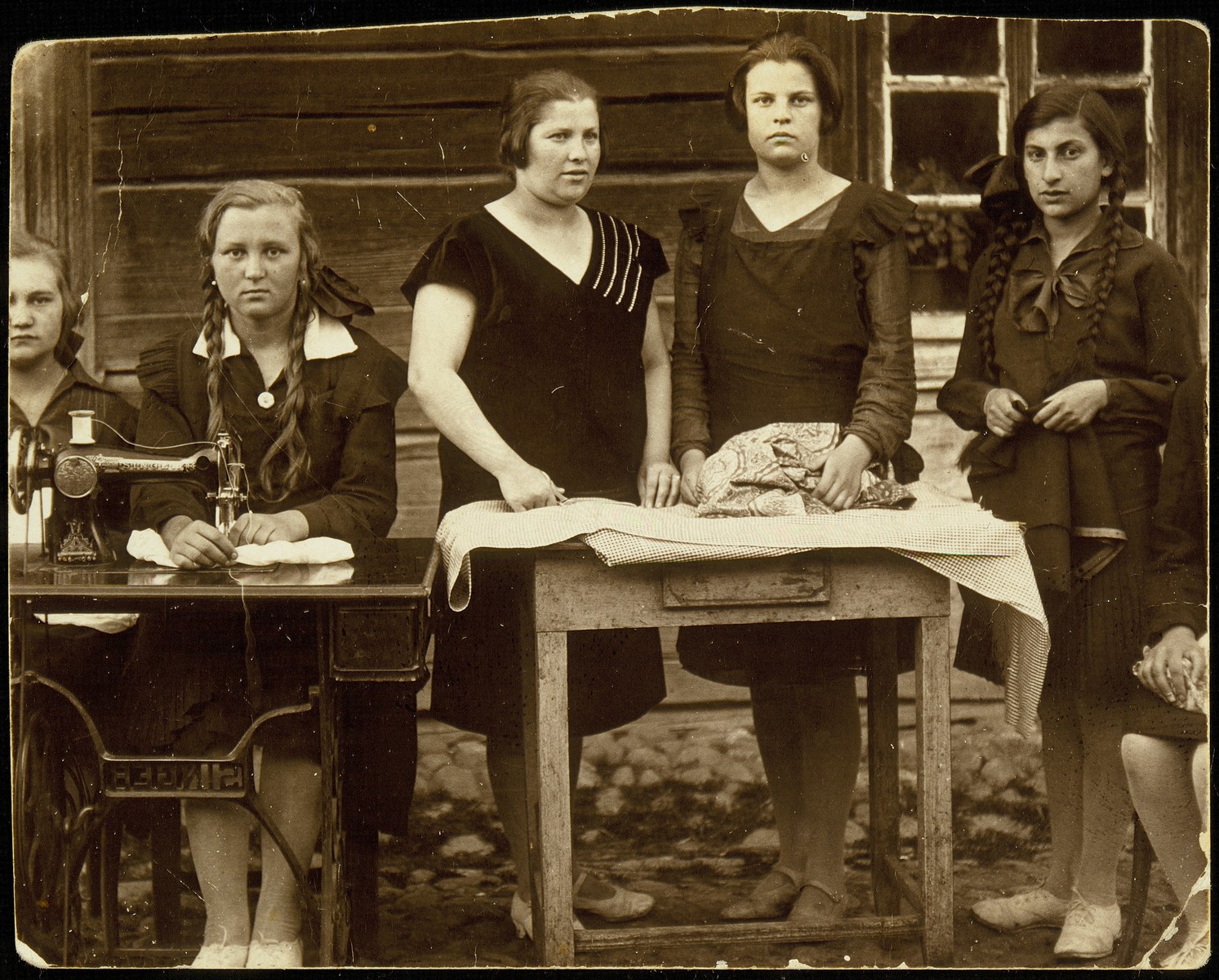 Young women attend a sewing class taught by a master seamstress from Vasilishok.

Sitting from right to left: Rozka Chesler from Vasilishok, first name unknown Pochter, Rivka, the seamstress, Dora Zlotnik, unknown.  Dora immigrated to Palestine.  All the other women were murdered during the Holocaust.