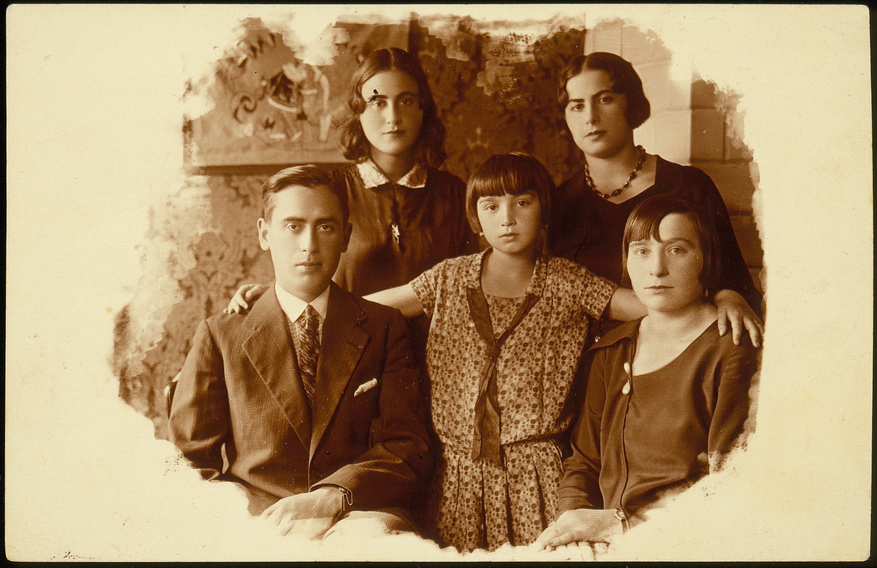 Portrait of members of the Kudlanski and Dubrowicz families in Eisiskes.

Pictured in the front row from right to left is: Hanneh-Beile (Moszczenik) Kudlanski, her daughter Atare Kudlanski  and her cousin Shaul Hayyim Dubrowicz.  Standing behind from right to left are Shaul's sisters,  Leah and Chava Dubrowicz. This photo was mailed by Hanneh-Beile to her two sisters, Sarah Moszczenik and Fradl (Moszczenik) Yrukanski.  Hanneh-Beile and her daughter Atara immigrated to the United States before the war.  The Dubrowicz siblings and their families perished during the Holocaust.