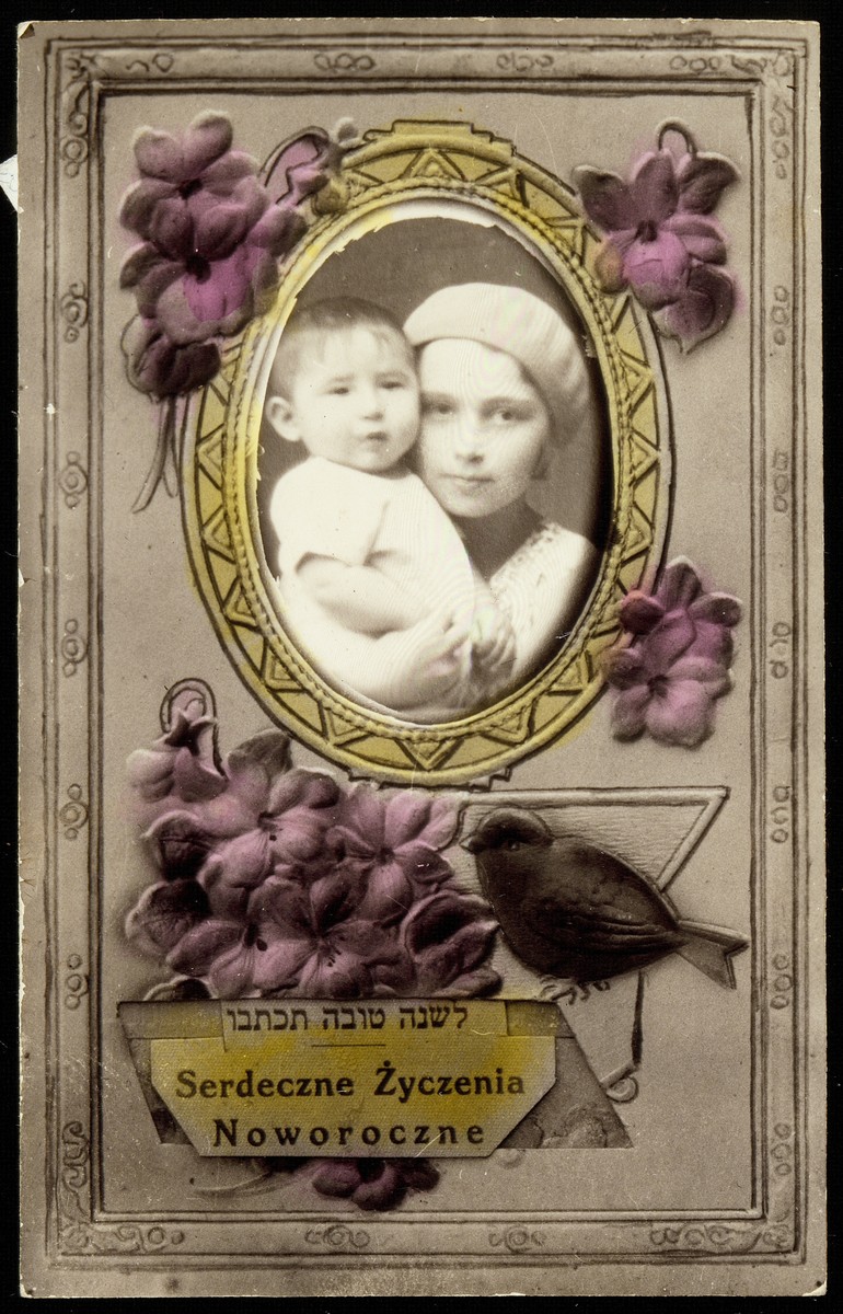 Jewish New Years card with a photo of a young girl cuddling an infant.  

Atara Kudlanski (Goodman) is pictured with her baby cousin, Yudaleh Kabacznik.  The card was sent from Eisiskes to their Aunt Sarah in Detroit.  Yudaleh was murdered by the Polish Home Army in 1944.