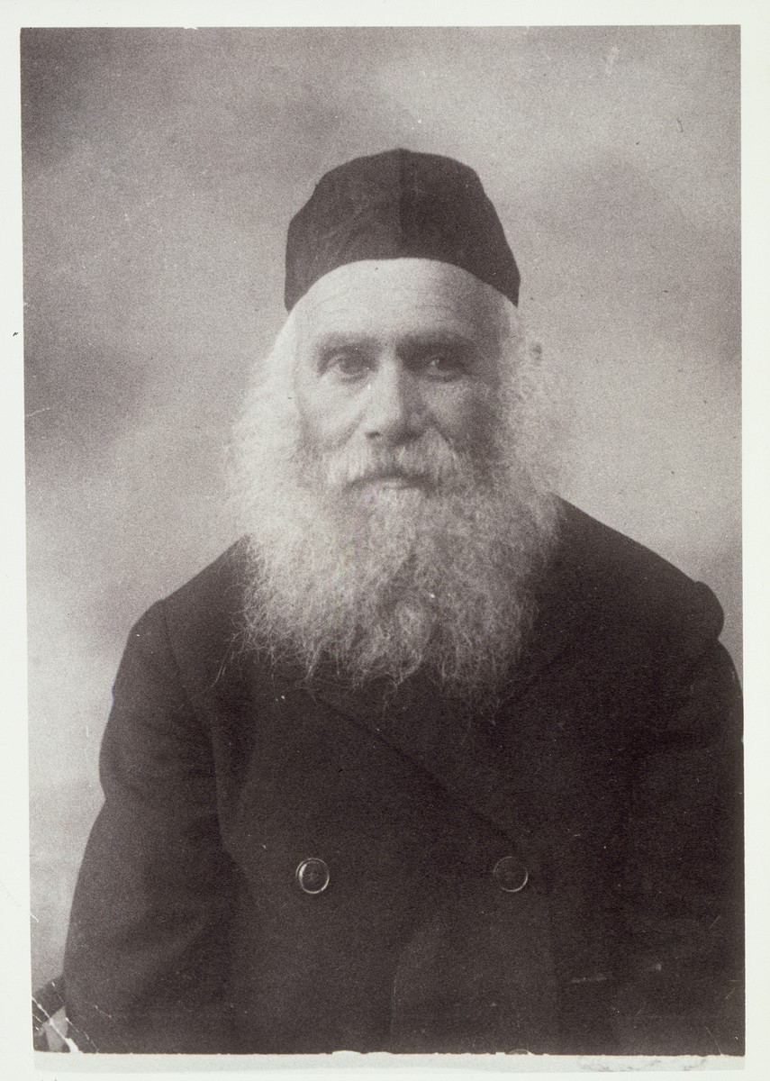 Photo of Reb Arieh-Leib "der Rubishker" (from Rubishok) Kudlanski, Eisiskes' milkman. 

Every Saturday morning, he used to walk to the shtetl's Old Beth Midrash in his prayer shawl.  When he passed by, Christian and Muslim farmers removed their hats in his honor. All of his children immigrated to America.  He visited them but decided to return to Eisiskes stating that he did not like a country "where people love more the people who walk on the walls [people in the movies] than real people who walk on the fields and streets."  When he was in  his eighties, the Germans cut his beard and then killed him during the September 1941 mass shooting action in Eisiskes.