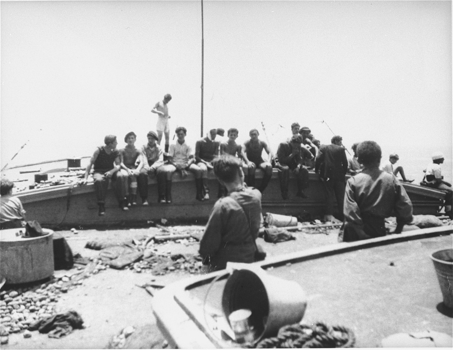 Jewish passengers rest on the deck of the Exodus 1947 amidst the debris from the previous night's struggle.