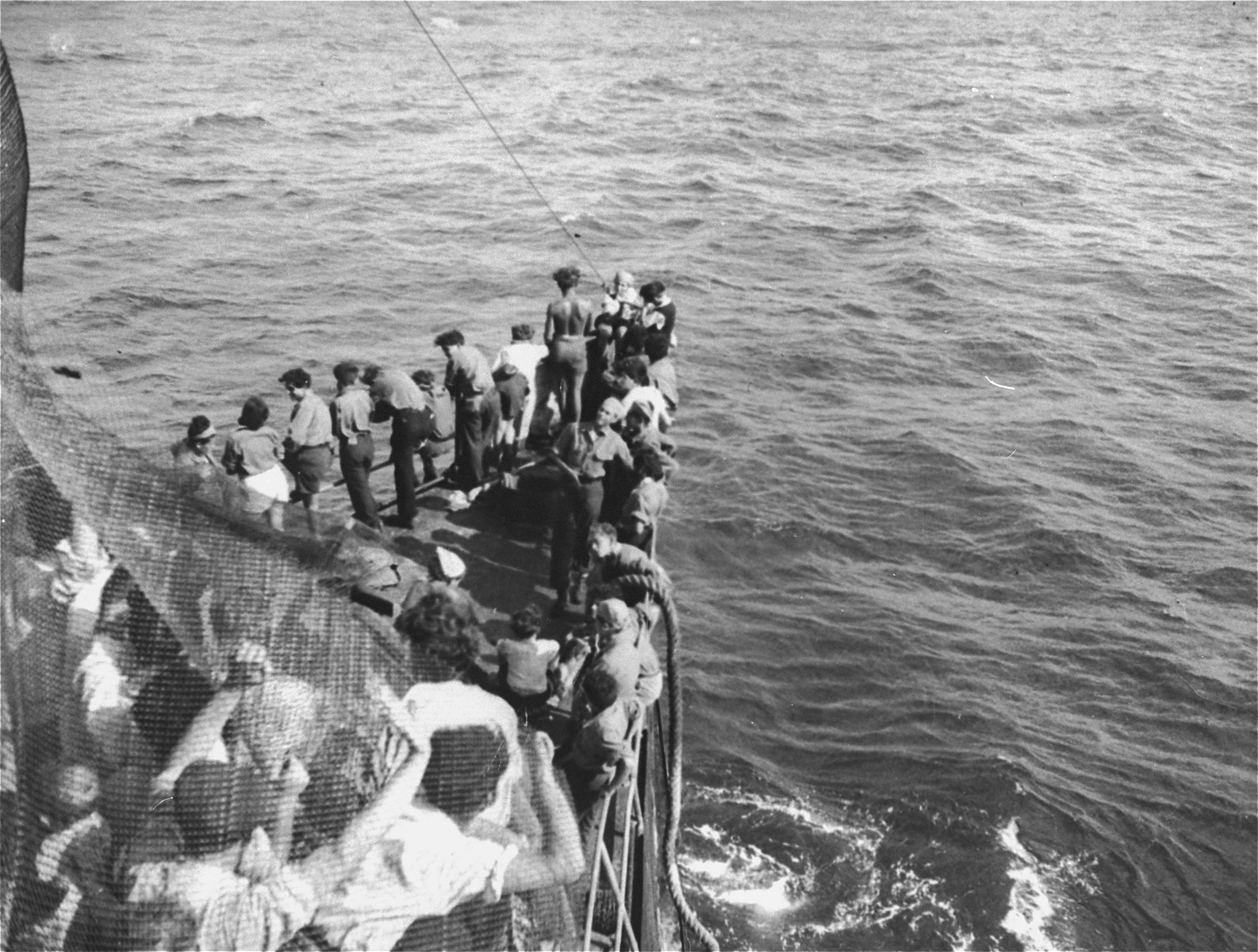 Jewish passengers crowd the bow of the Exodus 1947 as it is towed into the port of Haifa.