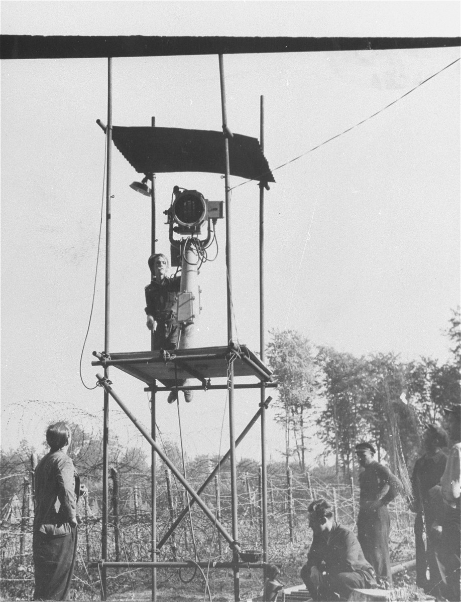 A British soldier guards the Poppendorf DP camp from a searchlight tower.
