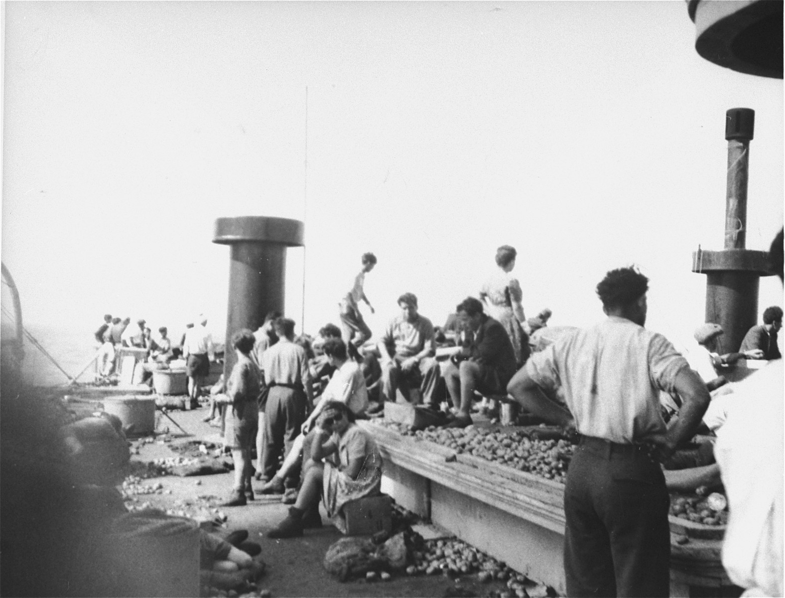 Jewish passengers rest on the deck of the Exodus 1947 amidst the debris from the previous night's struggle.