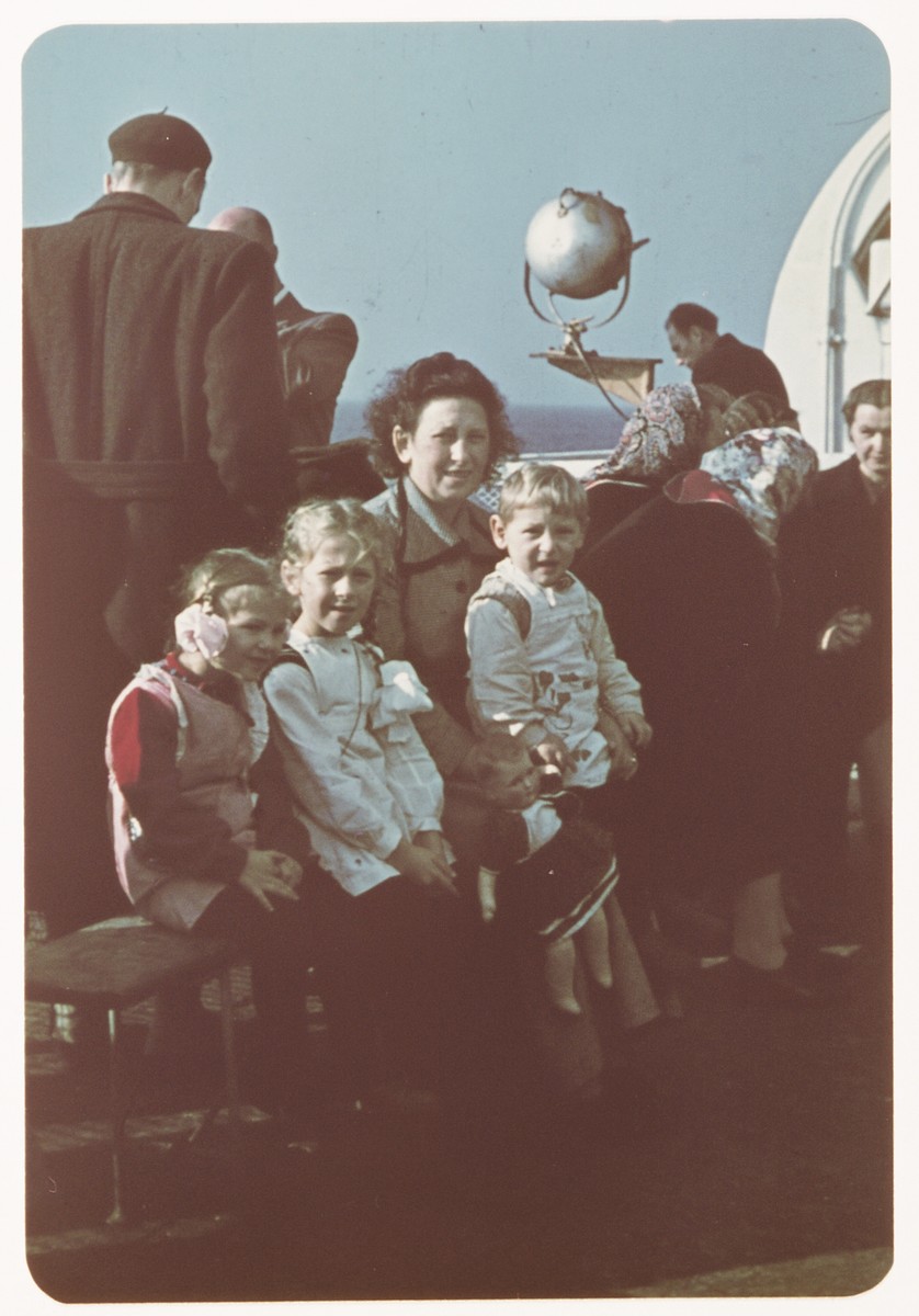 Sarah Spiegel Robinson poses with her  three young children on the deck of  the ship taking bringing them to the United States.