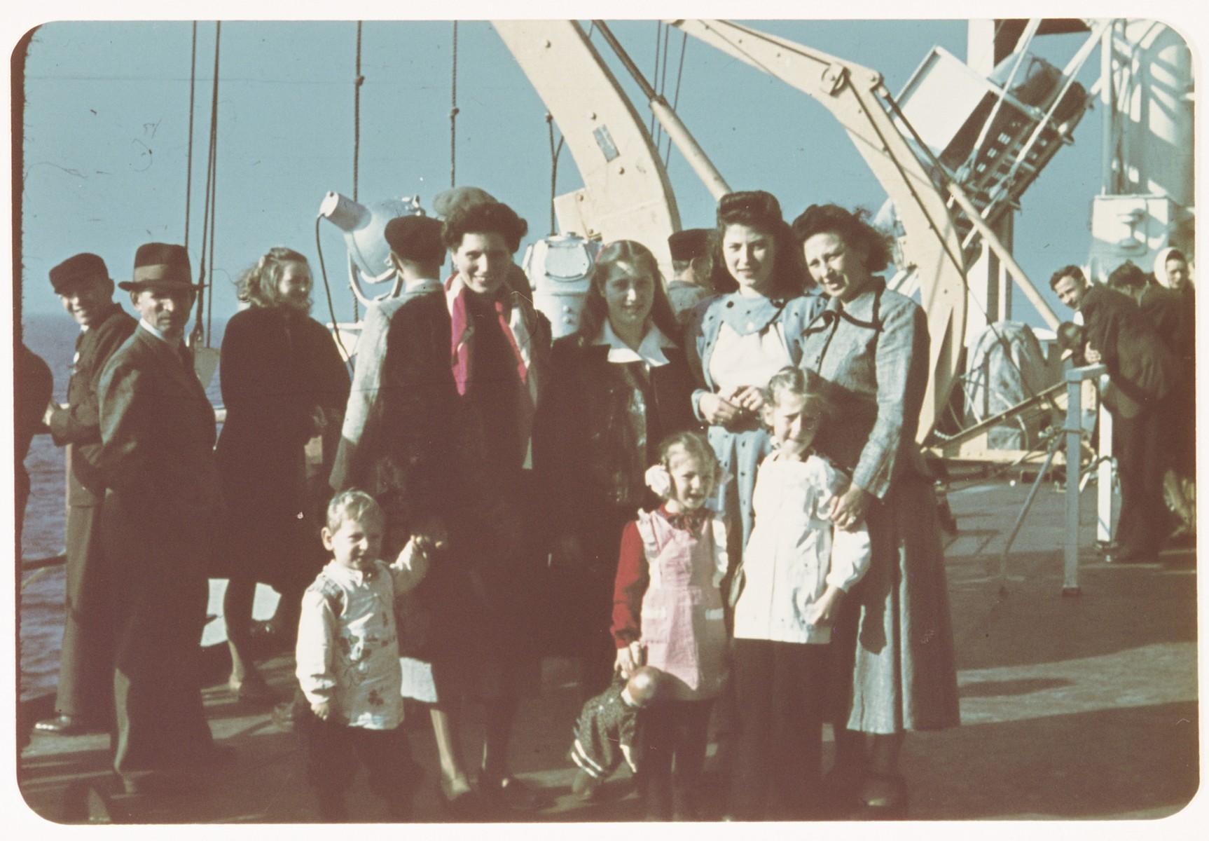 Sarah Spiegel Robinson poses with another family and her  three young children on the deck of  the ship taking bringing them to the United States.