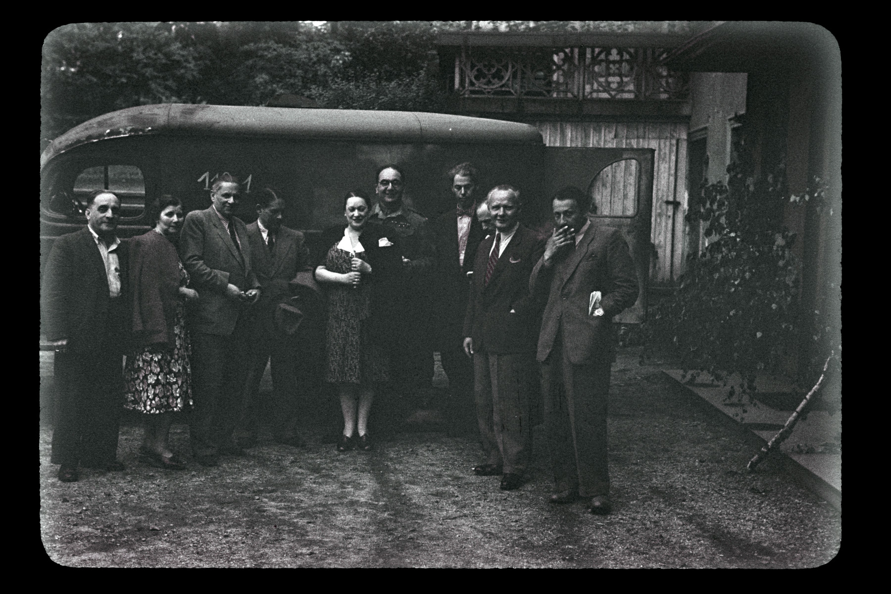 Group portrait of people posing in front of a bus in Upper Silesia.