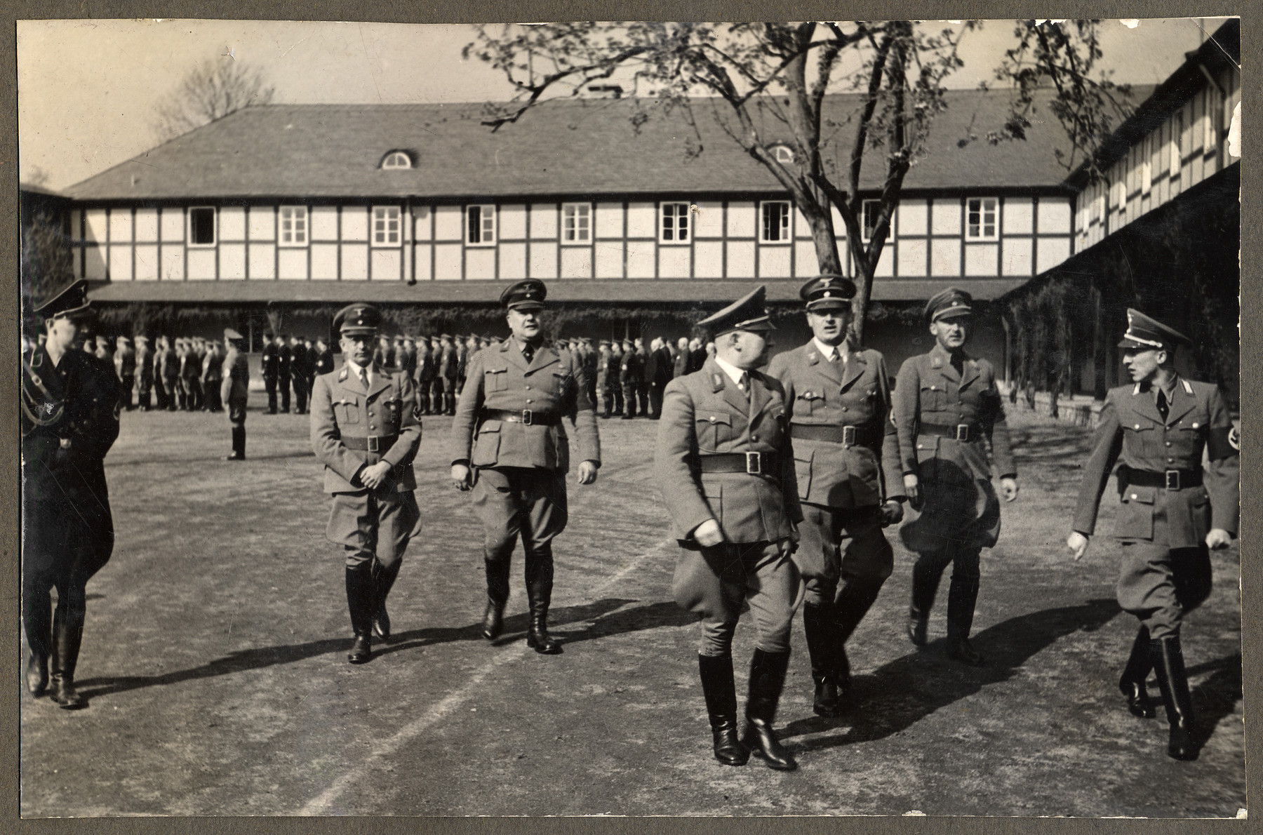 Nazi officials walk in a courtyard at the seminar for Reich training in Erwitte.