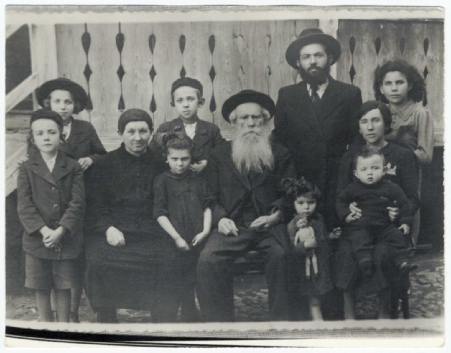 Group portrait of the family of Rabbi Fishel Ostreicher.  He is pictured with his parents and children.

Rabbi Ostreicher served as secretary of the Jewish community in Munkacs.