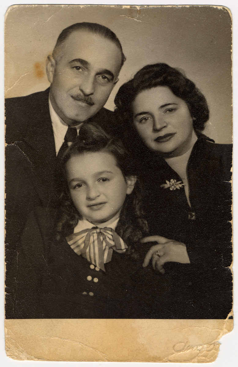 Studio portrait of a Hungarian Jewish family who survived the last year of the war in hiding.

Pictured are Rabbi Michael, Lillian and Zsuzsa Rubin.