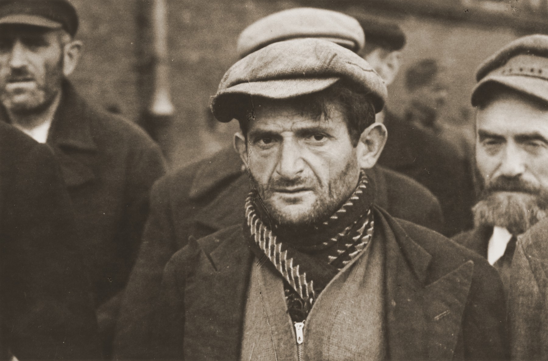 Close-up of a group of Jewish men who have been rounded-up by German soldiers in Aleksandrow Kujawski .