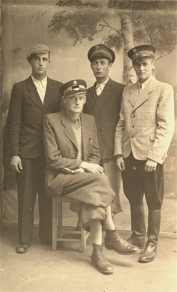 Group portrait of four Jewish policemen in the Kolbuszowa ghetto.  

Seated is Josek Rappaport, commandant. Standing, from left to right are: Jankel Lejbowicz; Mendel Bilfeld and Binem Rozenbaum.