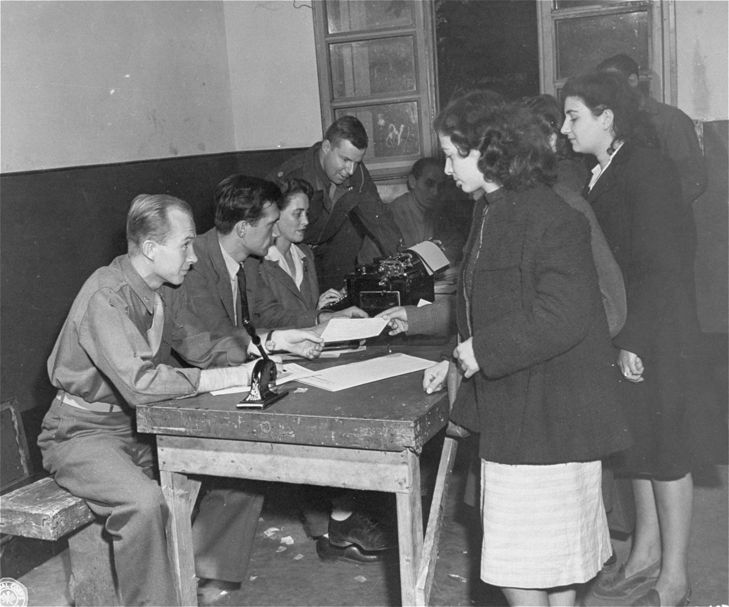 Jewish DPs en route to Palestine undergo a registration process in Rome.

Among those pictured are Eugene Hammond, representative of the Intergovernmental Commission on Refugees, and Major George Hartman, Allied Commission Repatriation Officer.