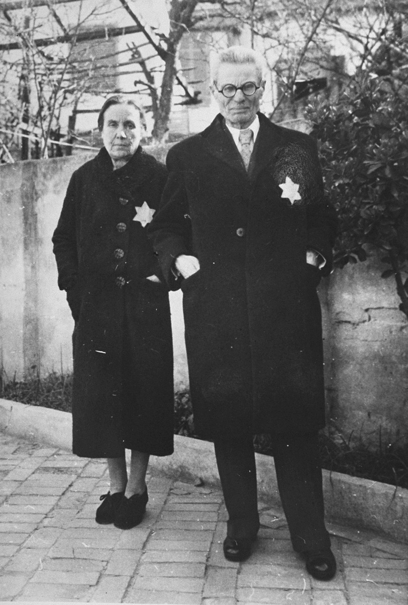 A Jewish couple wearing the yellow star poses on a street in Salonika.

Pictured are Rachel and Joseph Chasid, the parents of Margo (Chasid) Melech.