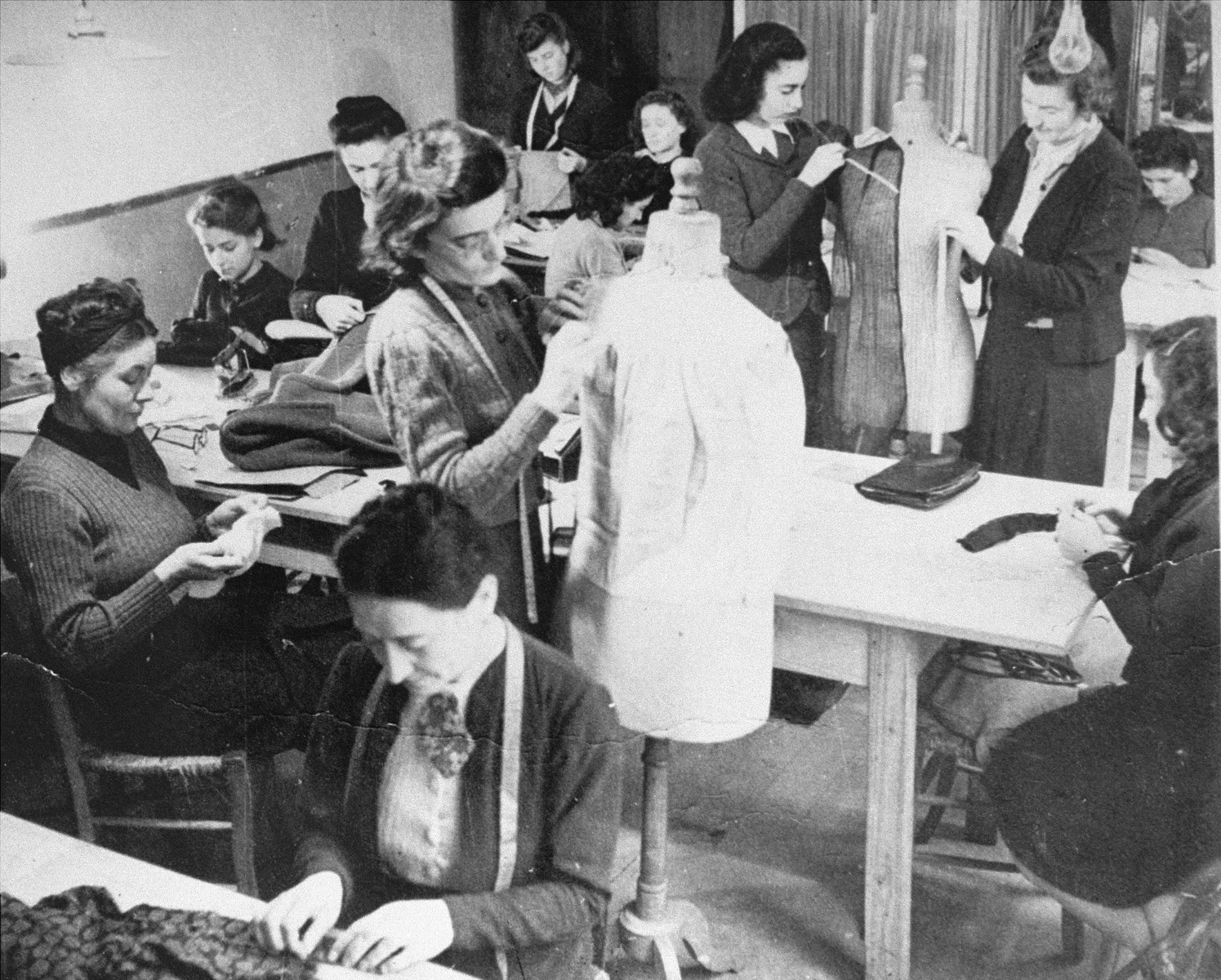 Women learn dressmaking at an ORT vocational school.  

Pictured seated in the upper right hand corner is  Hermine Katz