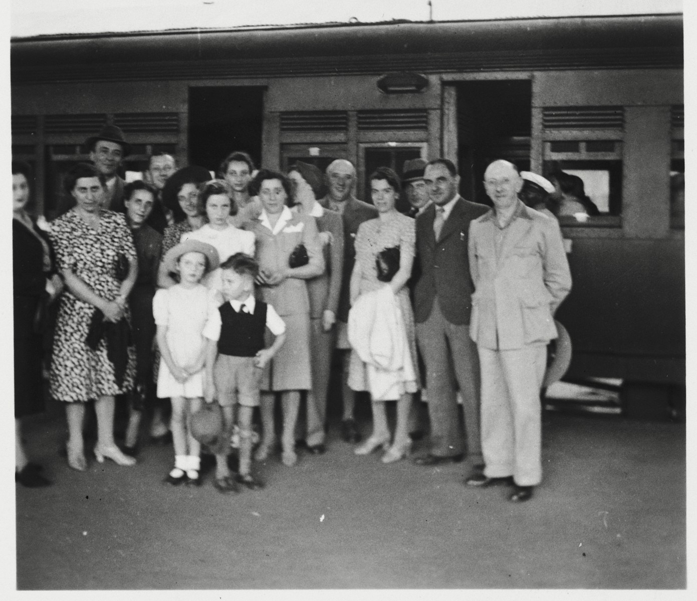 The Berg family is gathered on the platform at a train station in Kenya before their departure for the U.S. 

Pictured are Eliahu Fried, Sarah (Meyer) Berg, Sabina Lustman, Mrs. Bruckman, Erna (Meyer) Baum, Gisela Berg, Inga Berg, Klara Berg, Else Berg, Ernest Berg, Rosel (Marx) Berg, Mr. Bruckman, Adolf Baum and Josef Berg.