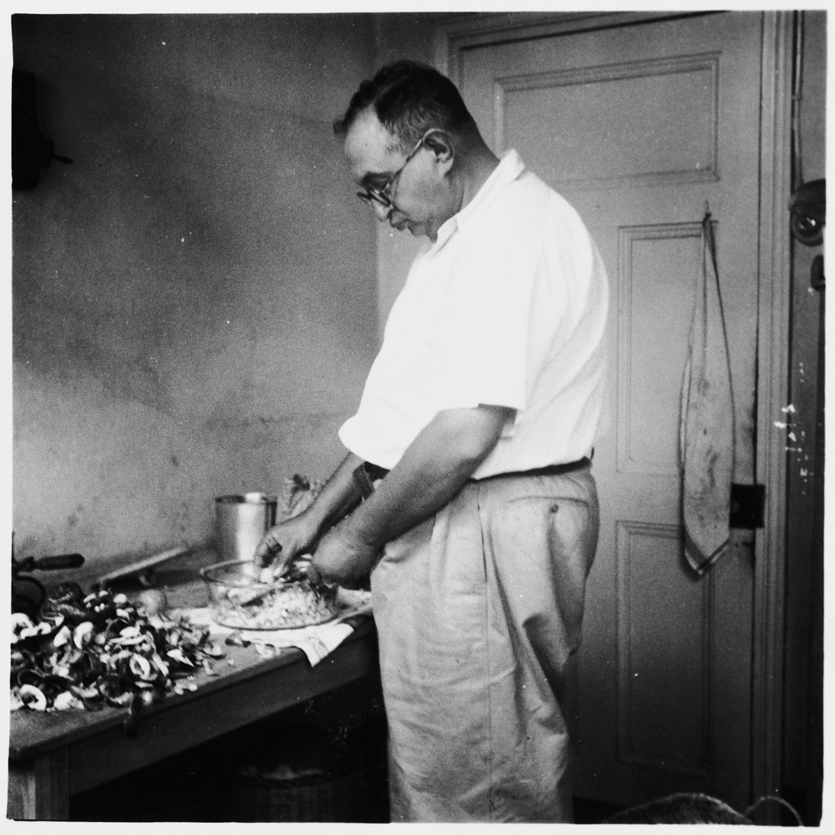 A German Jewish refugee prepares food for Passover in his home near Limuru, Kenya (Kiambu district), where his family found refuge during World War II.

Pictured is Joseph Berg.