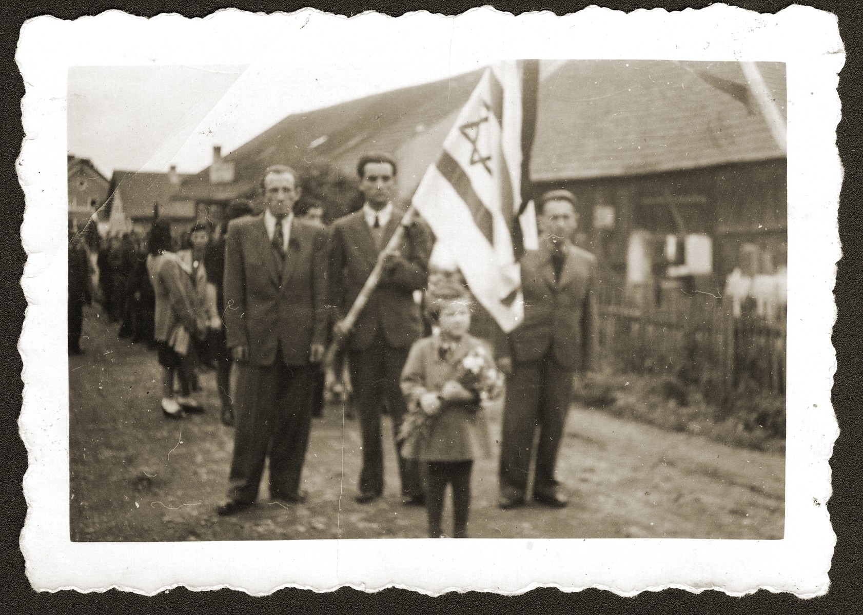 Mania Sztajman leads a procession of DPs to the Jewish cemetery near Woerth an der Donau, where they will celebrate Israeli Independence Day.