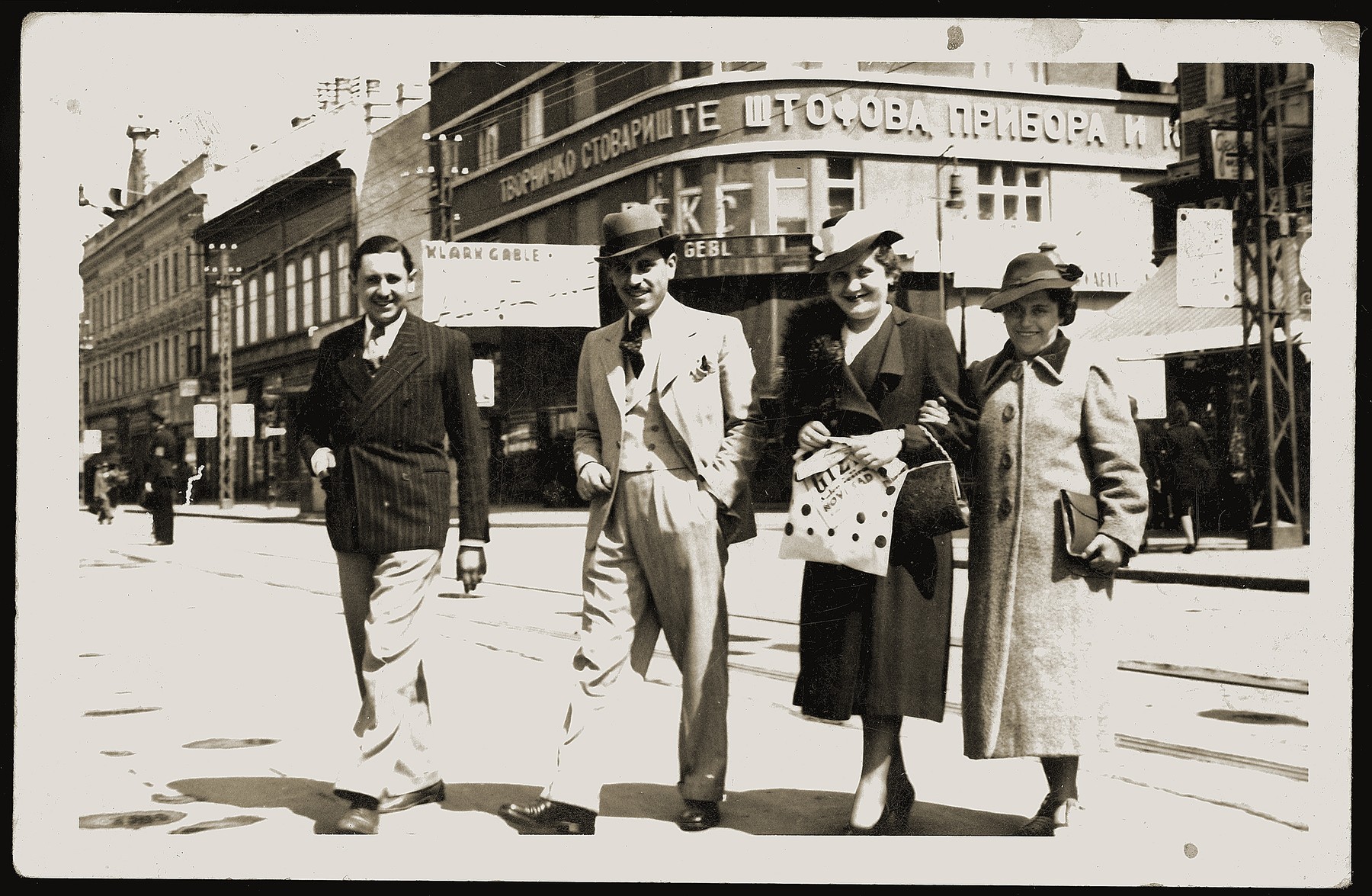 Members of the Mandil family pose on a street in Novi Sad, Yugoslavia.

Pictured are Mosa (Moshe) and Gabriela Mandil (center) with his Mosa's sister Streja (right) and a friend.