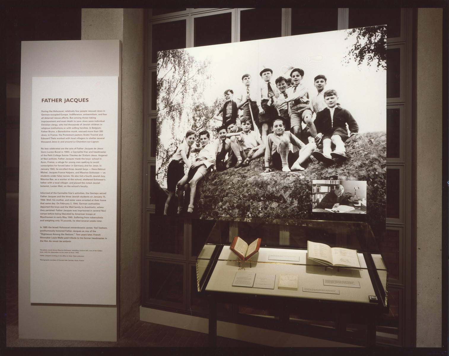 Mural and artifact display case of special exhibit "Father Jaques" in the concourse of the U.S. Holocaust Memorial Museum, May through October 1997.