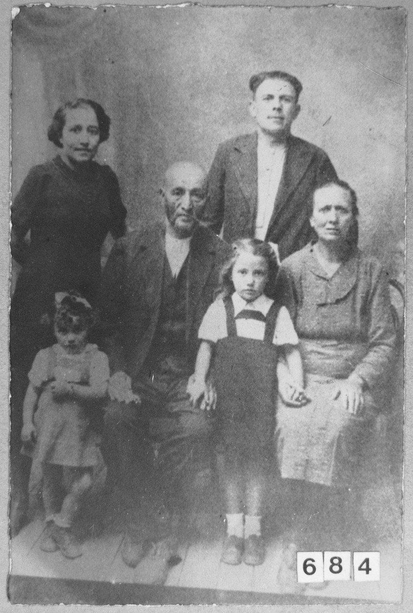 Portrait of Menachem Todelano, his wife, Miram, Mordechai Massot and his wife Luna.  Menachem was a second-hand dealer.  Menachem and Miriam lived at Bistritska 9 in Bitola.  Mordechai was a rag dealer.  Luna was a laundress and she lived at Sinagogina 12 in Bitola.  Also pictured are two unidentified children.
