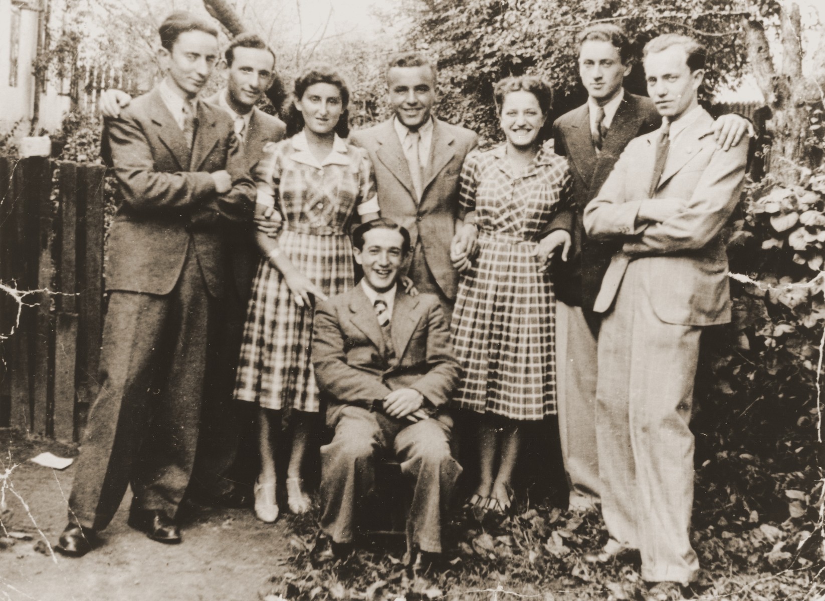 Group portrait of Jewish high school friends in Brody, Poland.

Pictured standing from left to right are: unknown, Henryk Lanceter, Ms. Buchbinder, Jacob Tomaszower, unknown, Mr. Korn, and Nathan Shapira. Seated is David Sirota.