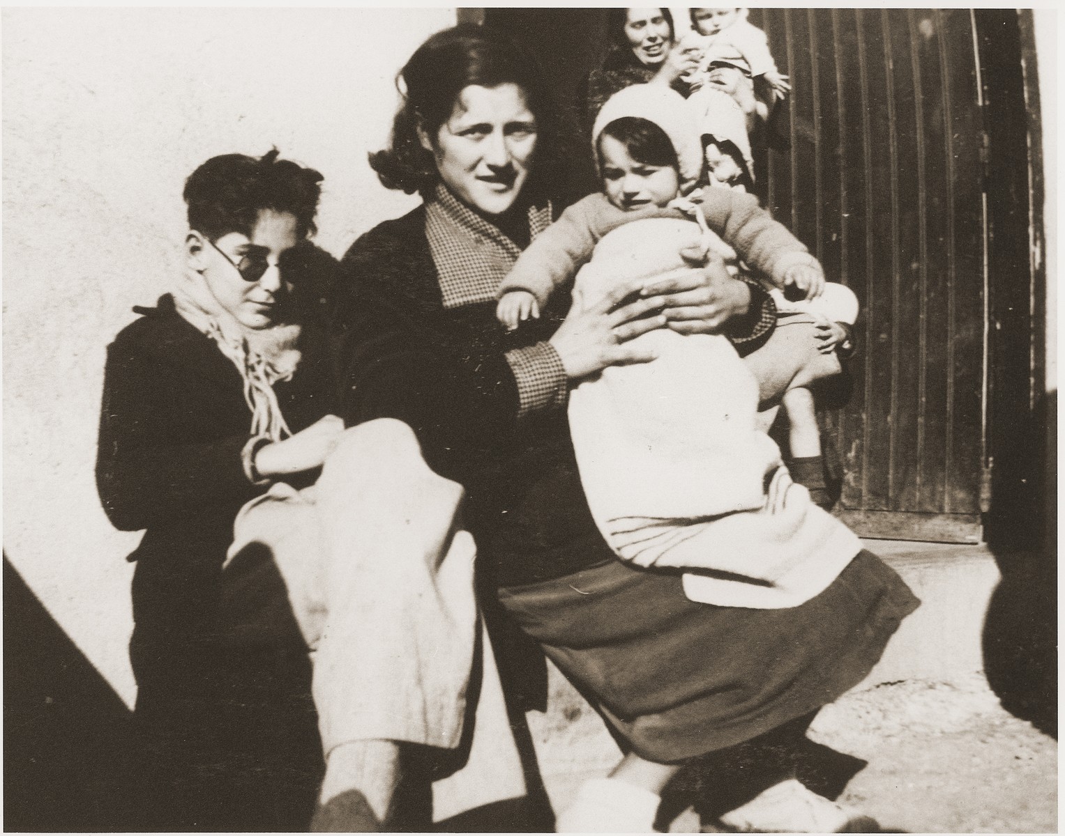 A Spanish family that was injured during the Spanish Civil War sits outside a barracks in the Rivesaltes internment camp.