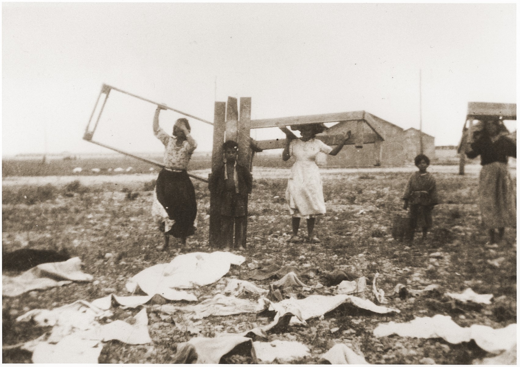 Internees move their bed frames to new quarters in the Rivesaltes internment camp.