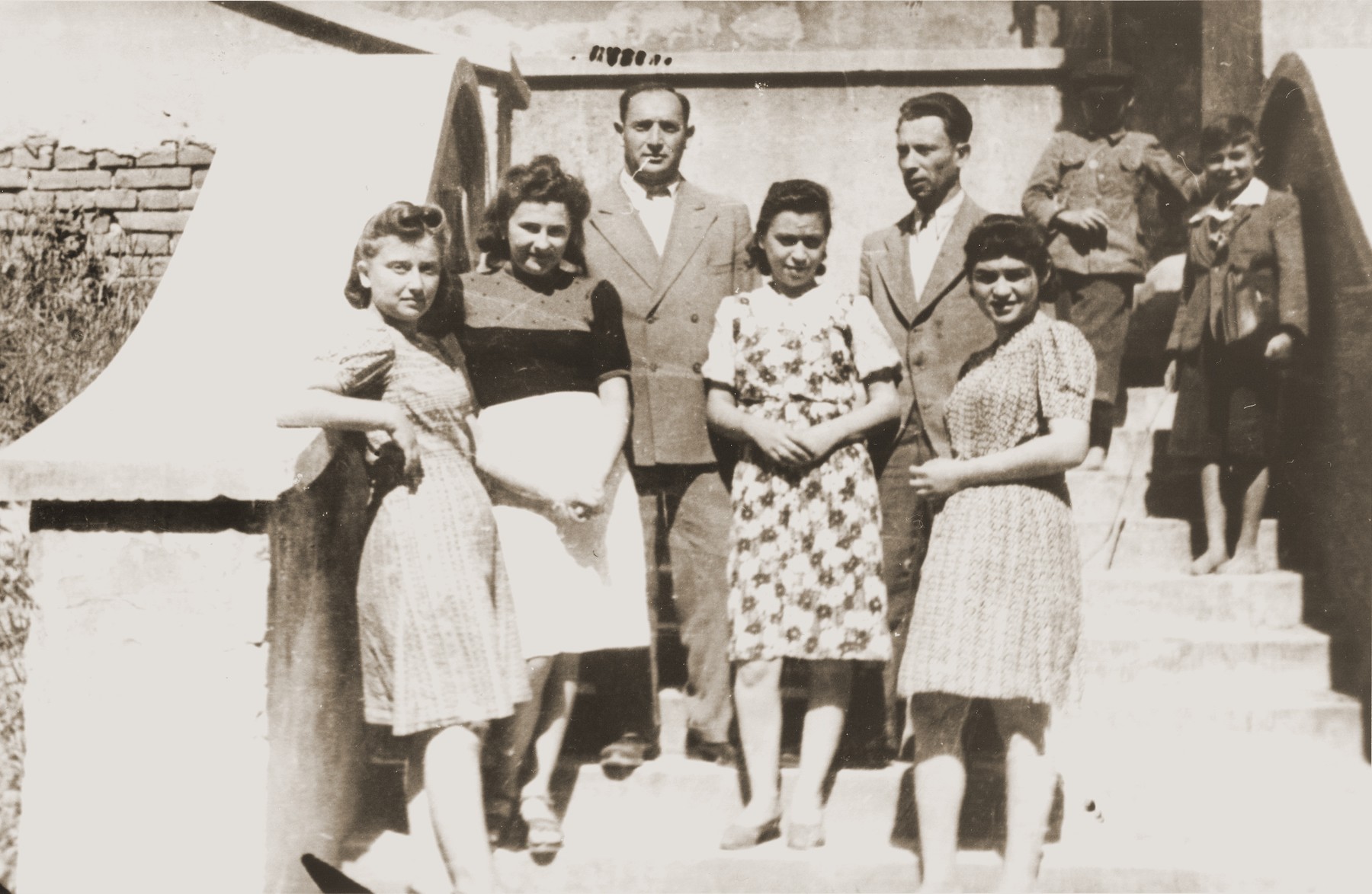 Group portrait of young Jewish DPs on the steps of a building in Lublin.

Pictured from left to right are: Rosa Lerner (Friedrich), Fryda Israelovitz (Bukar), unknown, Ms. Metches, Munio Kaczer (Kaiser), and Eugenia (Hochberg) Lanceter.