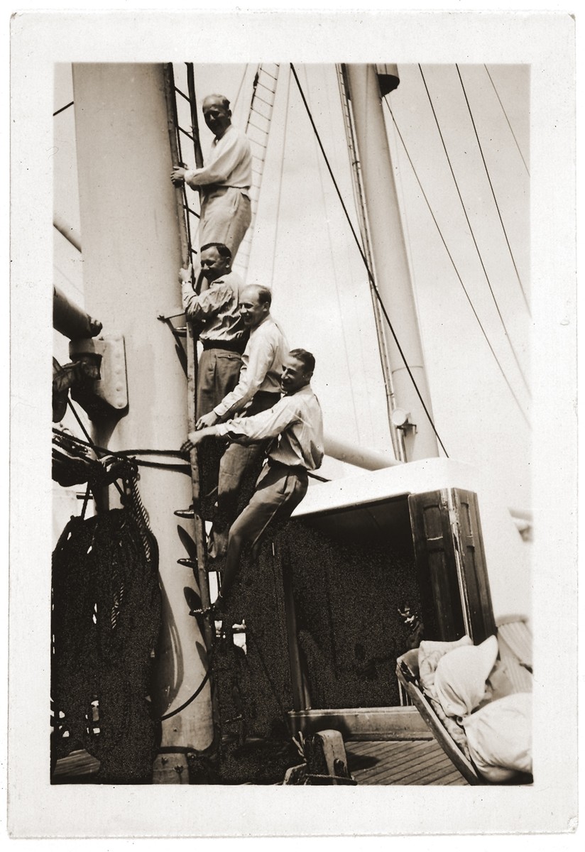 Four Jewish refugee friends pose while climbing a mast ladder on the deck of the SS St. Louis.

Among those pictured is Oskar Blechner (second from the bottom).