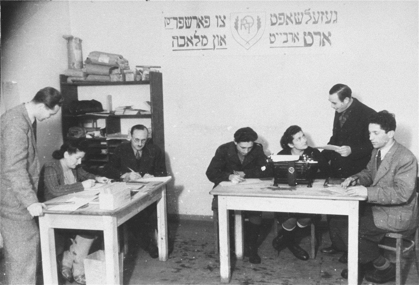 ORT office in the camp.
The man pictured on the right speaking to the secretary is Jana Wisgardisky.