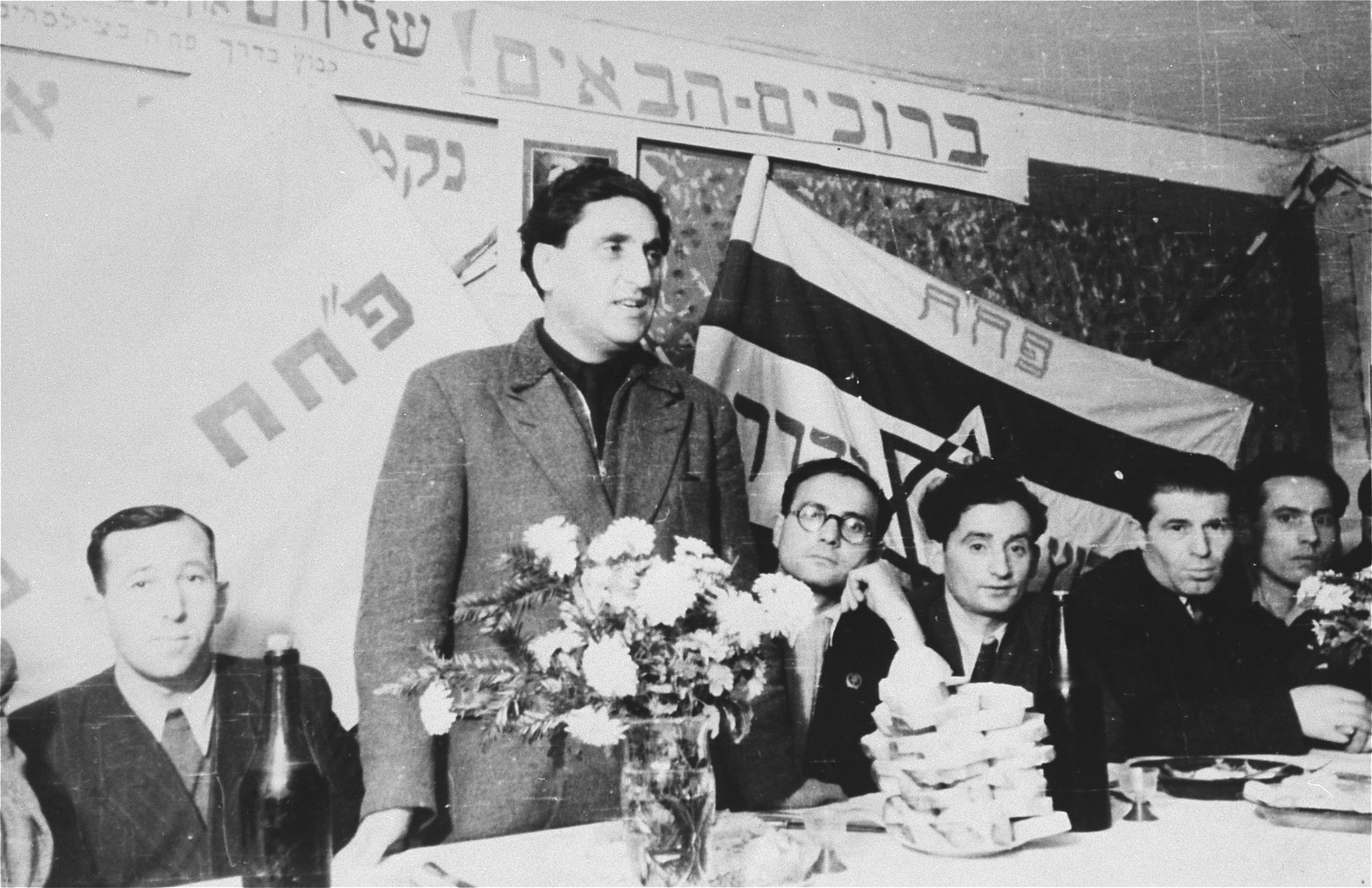 An unidentified man addresses the audience in a P.H.H. Zionist political meeting in the Zeilsheim displaced persons' camp.