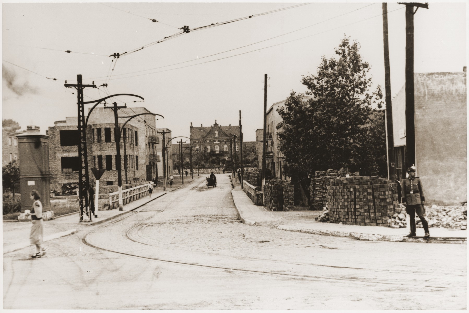 A German policeman stands guard at the site of a destroyed building in Bedzin.