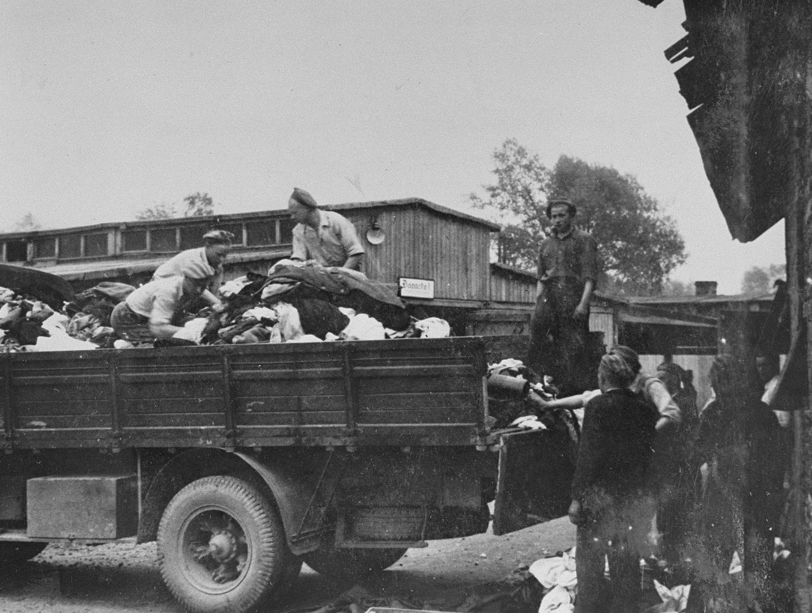 Prisoners in the Aufräumungskommando (order commandos) unload the confiscated property of a transport of Jews from Subcarpathian Rus at a warehouse in Auschwitz-Birkenau.

The camp prisoners came to refer to the looted property as "Kanada," associating it with the riches symbolized by Kanada.  The members of this commando were almost exclusively Jews.  "Kanada" storage facilities occupied several dozen barracks and other buildings around the camp.  The looted property was funneled from Auschwitz through an extensive distribution network that served many individuals and various economic branches of the Third Reich.