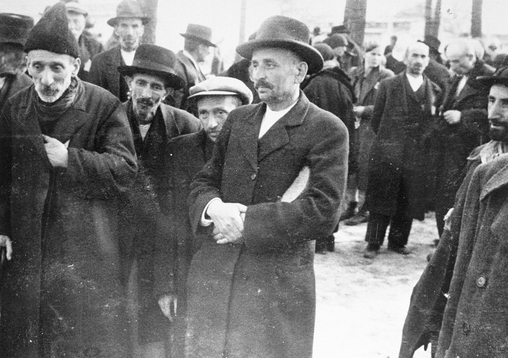 Jews from Subcarpathian Rus who have been selected for death at Auschwitz-Birkenau, wait to be taken to the gas chambers.