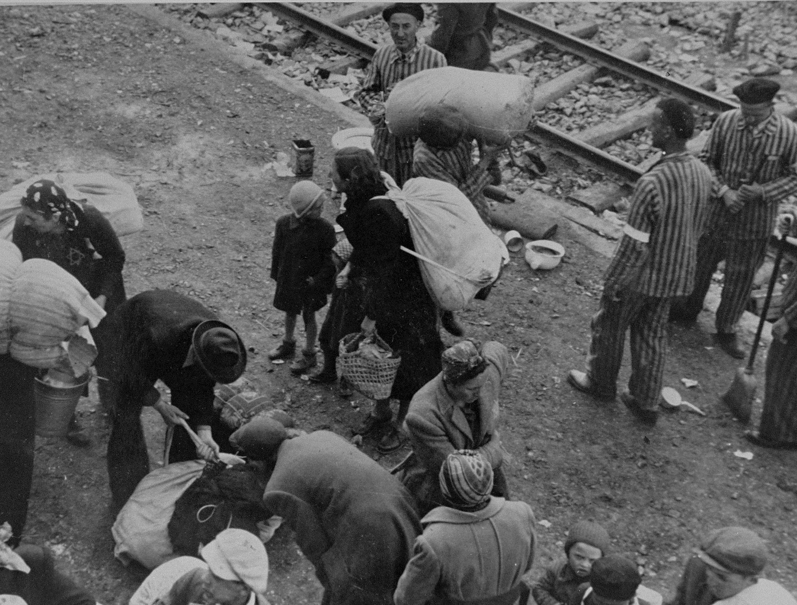 New arrivals to Auschwitz from Subcarpathian Rus attend to their personal belongings.