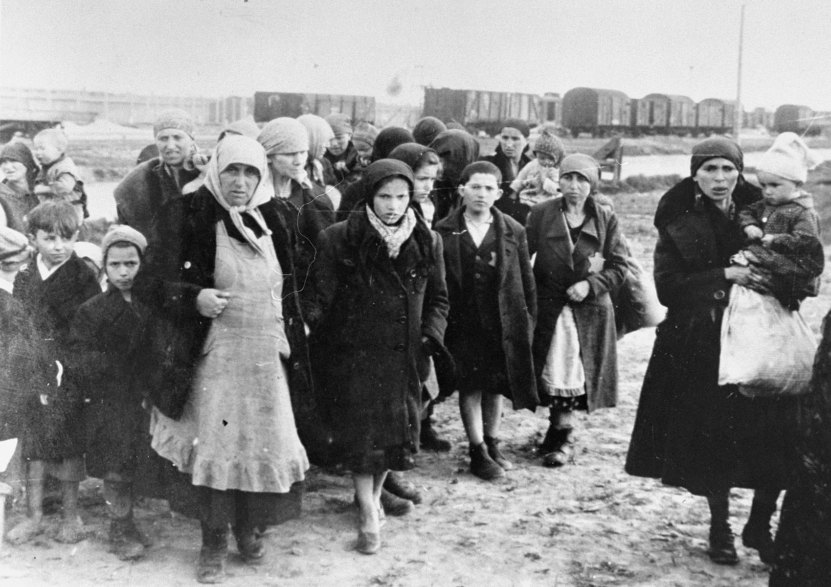 Jewish women and children from Subcarpathian Rus who have been selected for death at Auschwitz-Birkenau, wait to be taken to the gas chambers.