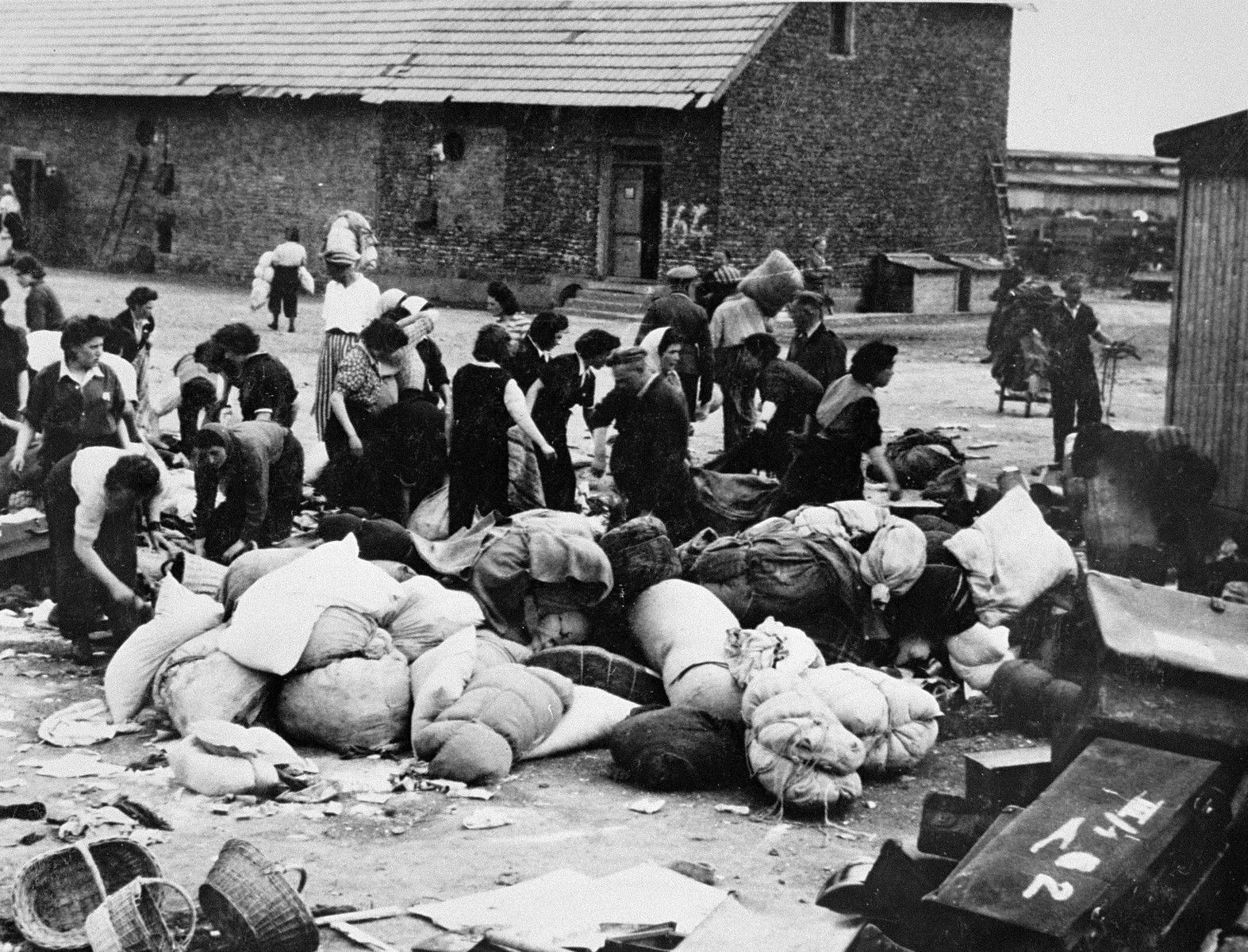 Prisoners in the Aufräumungskommando (order commandos) unload the confiscated property of a transport of Jews from Subcarpathian Rus at a warehouse in Auschwitz-Birkenau.

The camp prisoners came to refer to the looted property as "Canada," associating it with the riches symbolized by Canada.  The members of this commando were almost exclusively Jews.  "Canada" storage facilities occupied several dozen barracks and other buildings around the camp.  The looted property was funneled from Auschwitz through an extensive distribution network that served many individuals and various economic branches of the Third Reich.