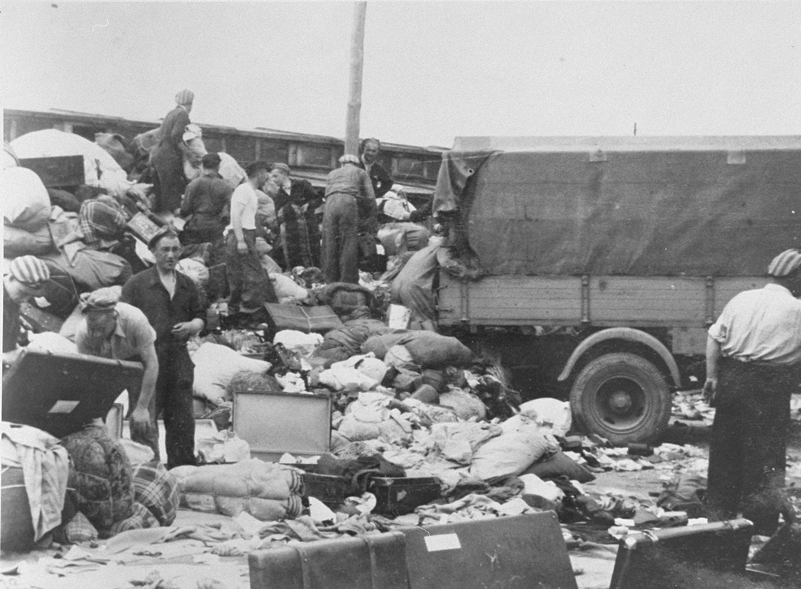 Prisoners in the Aufräumungskommando (order commandos) unload the confiscated property of a transport of Jews from Subcarpathian Rus at a warehouse in Auschwitz-Birkenau.

The camp prisoners came to refer to the looted property as "Kanada," associating it with the riches symbolized by Kanada.  The members of this commando were almost exclusively Jews.  "Kanada" storage facilities occupied several dozen barracks and other buildings around the camp.  The looted property was funneled from Auschwitz through an extensive distribution network that served many individuals and various economic branches of the Third Reich.