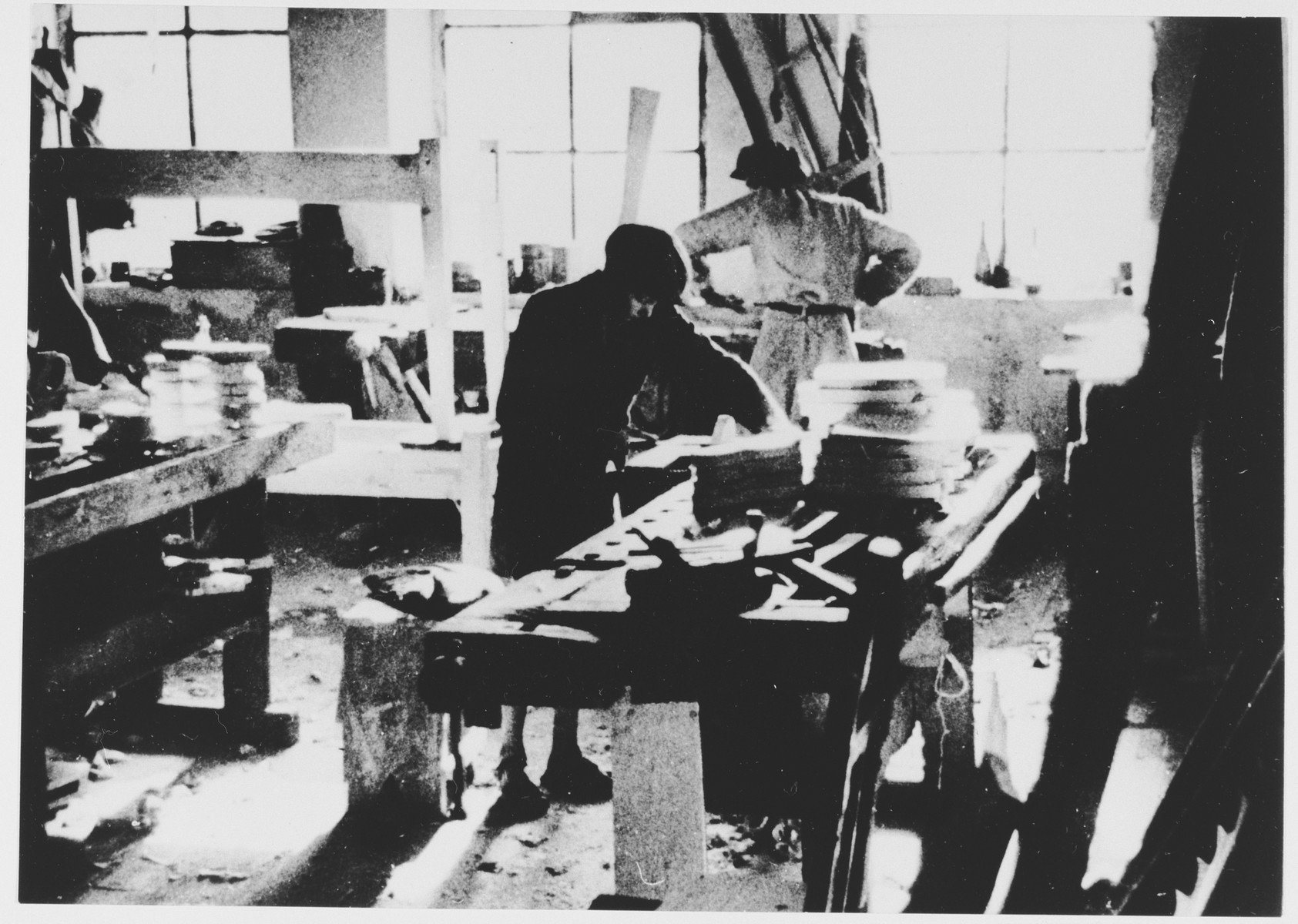 Prisoners labor in a saddle-making workshop in the Jasenovac III concentration camp.  This photograph was used for propagandistic purposes by the Ustasa.