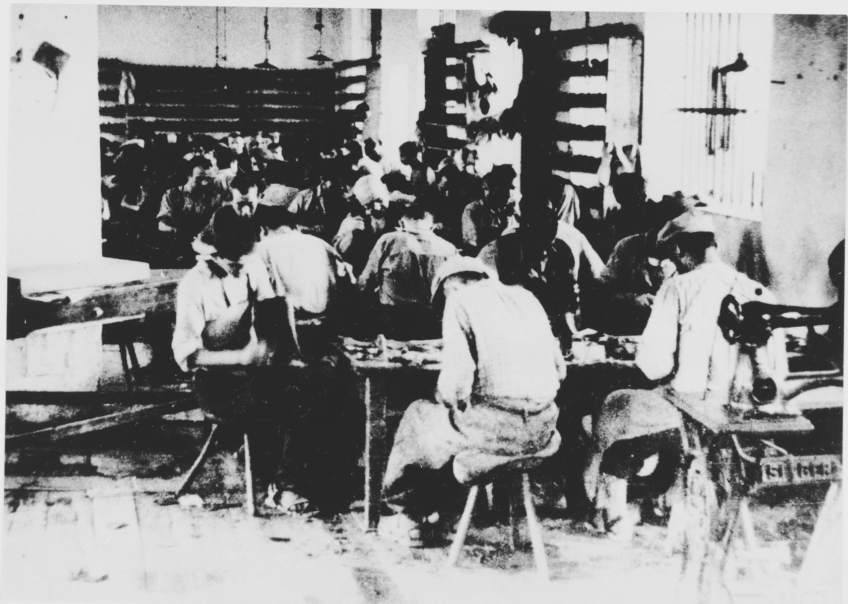 Prisoners labor in a shoe-making workshop in the Jasenovac III concentration camp.  This photograph was used for propagandistic purposes by the Ustasa.