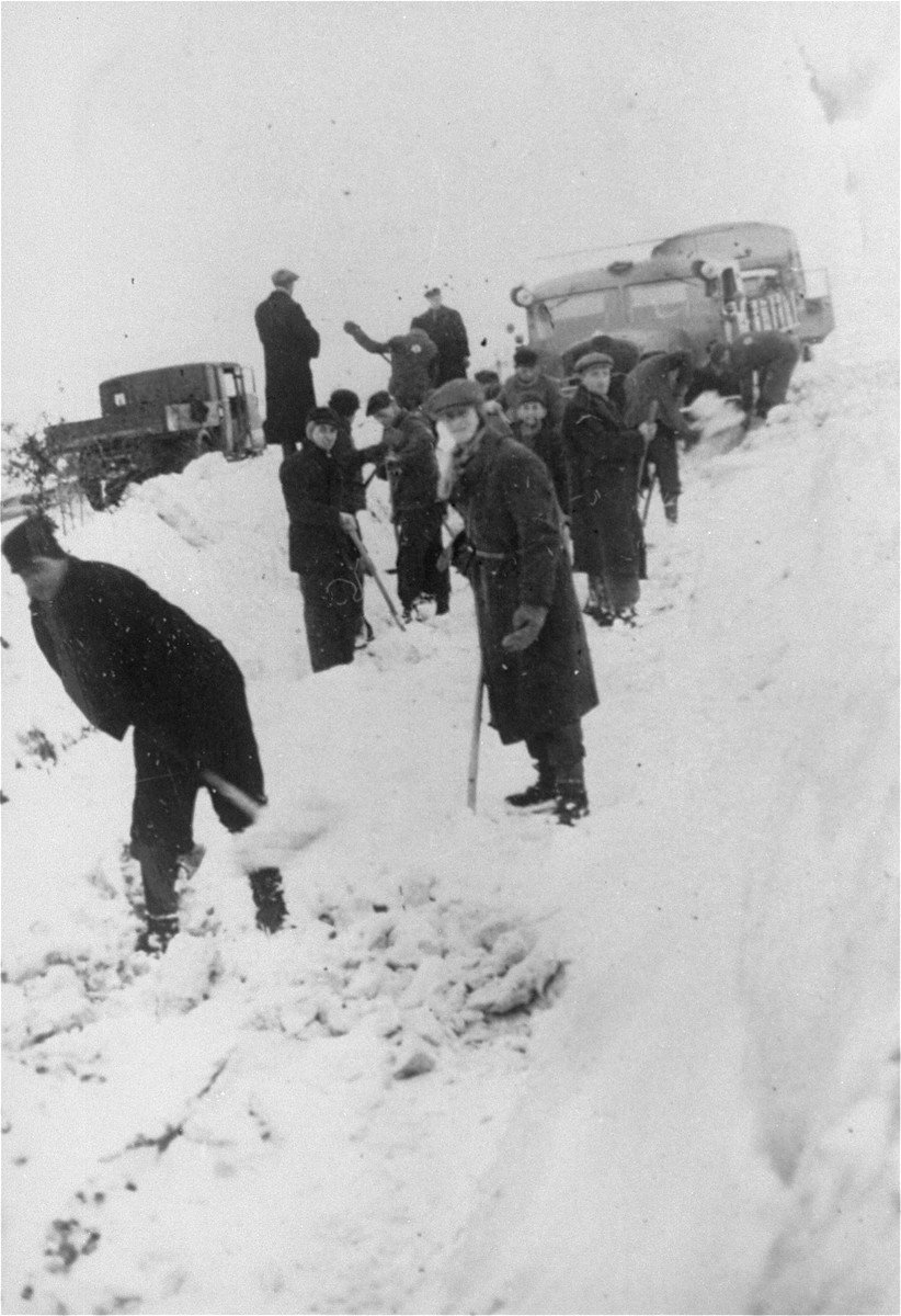 Jewish forced laborers from the Klettendorf labor camp shovel snow in preparation for the construction of the new autobahn between Breslau and Berlin.  

Jacob Hennenberg stands in front at the right.

The photograph was taken by a German guard who sent it to Jacob's sister in the Chrzarnow ghetto.