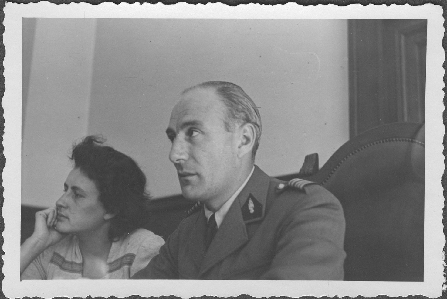 French Commissioner Colonel A. Martin-Havard listens to testimony at the IMT Nuremberg commission hearings investigating indicted Nazi organizations.  

Seated at the left is the commissioner's interpreter.