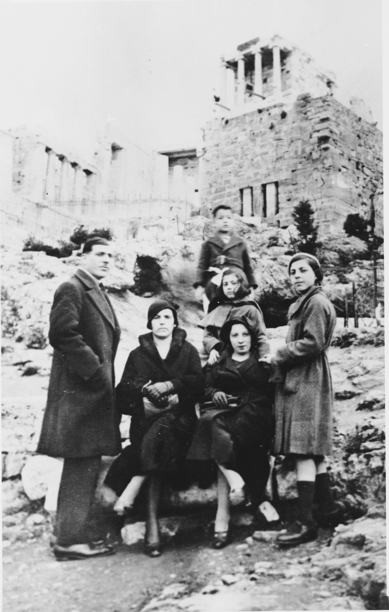 A family of Greek Jews poses at the Parthenon in Athens.

Pictured in front from left to right are Isaac Cases, Sarah (Kolonomos) Nehama, Donna Kolonomos Cases and Rachel Cases.  Standing behind in the center is Miriam Cases.  Standing at the top is Isaac Nehama.