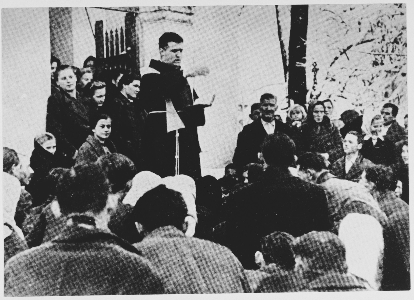 Serbian civilians are forcibly converted to Catholicism by a Croatian priest.